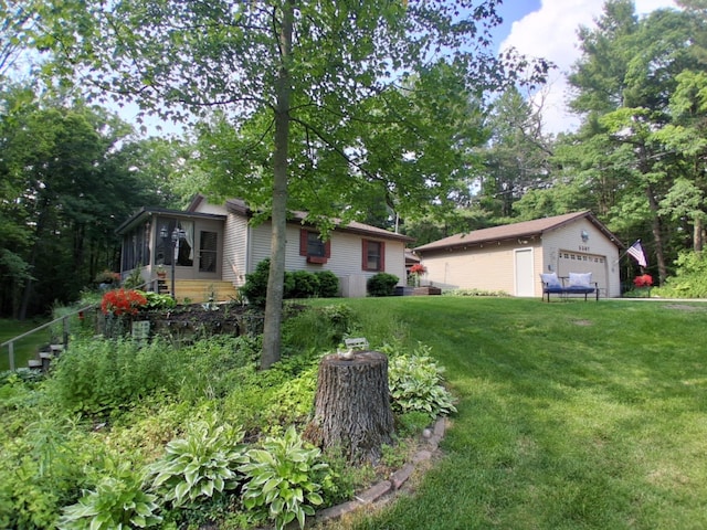 5397 E 80th St, Newaygo, MI 49337 - view of front of home featuring an outdoor structure, a sunroom, a garage, and a front yard