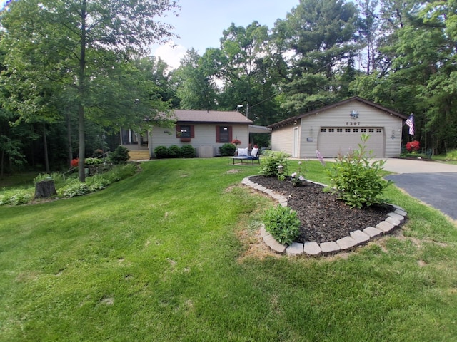 5397 E 80th St, Newaygo, MI 49337 - view of front of house featuring a front yard, an outbuilding, and a detached garage