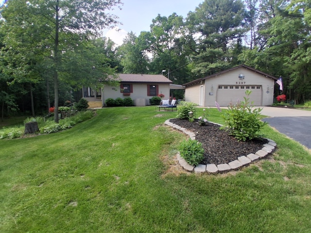 5397 E 80th St, Newaygo, MI 49337 - view of front of property with a garage, a front yard, and an outbuilding