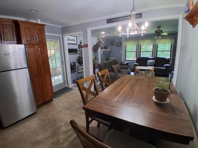 5397 E 80th St, Newaygo, MI 49337 - dining room with stone finish floors, a chandelier, ceiling fan, and ornamental molding