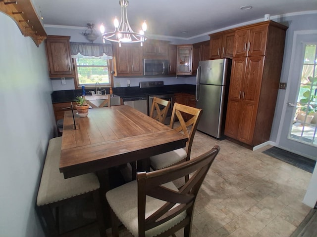 5397 E 80th St, Newaygo, MI 49337 - kitchen with appliances with stainless steel finishes, a chandelier, crown molding, dark countertops, and glass insert cabinets