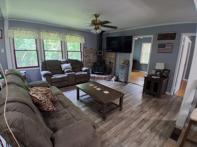 5397 E 80th St, Newaygo, MI 49337 - living room with a wood stove, ceiling fan, light wood-style floors, and ornamental molding