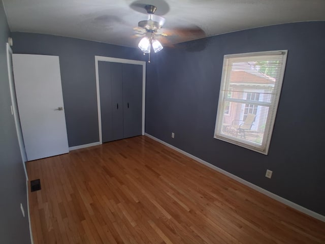 5397 E 80th St, Newaygo, MI 49337 - unfurnished bedroom with wood finished floors, a closet, and a ceiling fan