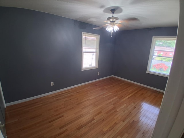 5397 E 80th St, Newaygo, MI 49337 - empty room with plenty of natural light, wood finished floors, and a ceiling fan
