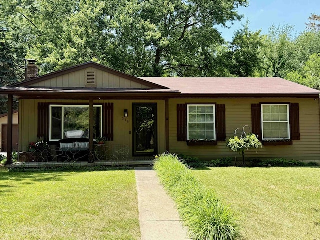 316 Colfax St, Fenton, MI 48430 - view of front of house featuring covered porch, a front yard, a chimney, and roof with shingles