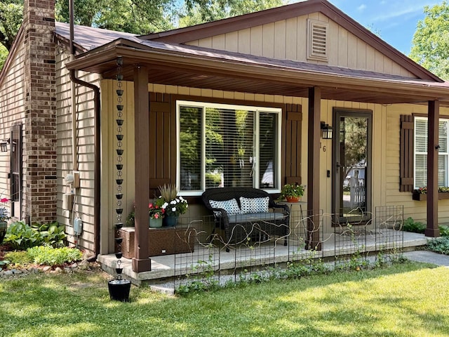 316 Colfax St, Fenton, MI 48430 - entrance to property featuring covered porch, a lawn, and a chimney