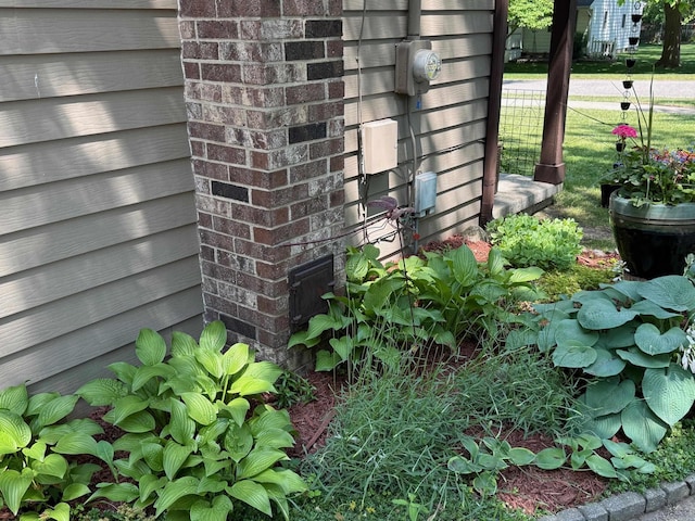 316 Colfax St, Fenton, MI 48430 - exterior view of electric meter and brick siding