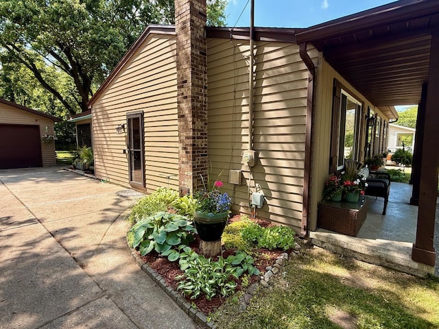 316 Colfax St, Fenton, MI 48430 - view of home's exterior featuring a chimney and an outbuilding