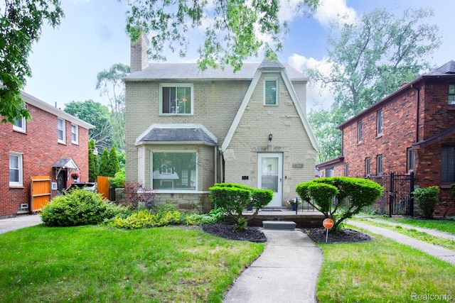 16728 Greenview Ave, Detroit, MI 48219 - tudor-style house featuring a chimney and brick siding