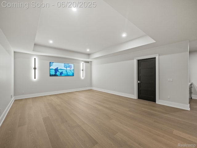 1120 Lyonhurst St, Birmingham, MI 48009 - unfurnished living room with a tray ceiling, light wood finished floors, and recessed lighting