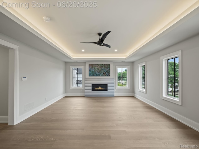 1120 Lyonhurst St, Birmingham, MI 48009 - unfurnished living room with a raised ceiling, ceiling fan, healthy amount of natural light, light wood-type flooring, and recessed lighting