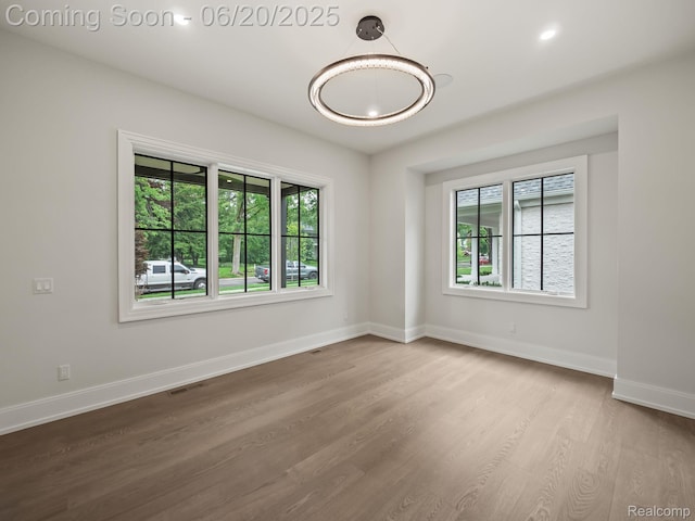 1120 Lyonhurst St, Birmingham, MI 48009 - unfurnished room with wood finished floors and a chandelier