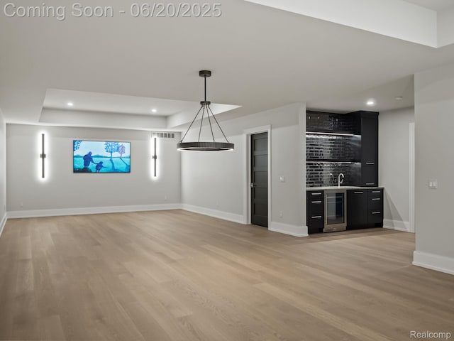 1120 Lyonhurst St, Birmingham, MI 48009 - unfurnished living room featuring bar with sink, light wood finished floors, wine cooler, and recessed lighting