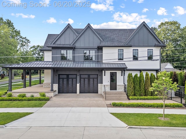 1120 Lyonhurst St, Birmingham, MI 48009 - modern farmhouse featuring a standing seam roof, a balcony, stone siding, board and batten siding, and an attached garage