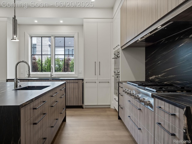 1120 Lyonhurst St, Birmingham, MI 48009 - kitchen featuring stainless steel gas cooktop, light wood-style floors, pendant lighting, modern cabinets, and recessed lighting