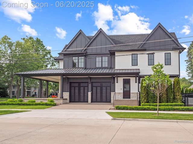 1120 Lyonhurst St, Birmingham, MI 48009 - view of front facade with a standing seam roof, concrete driveway, an attached garage, roof with shingles, and stone siding