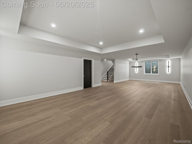 1120 Lyonhurst St, Birmingham, MI 48009 - unfurnished living room with a raised ceiling, stairway, wood finished floors, and recessed lighting