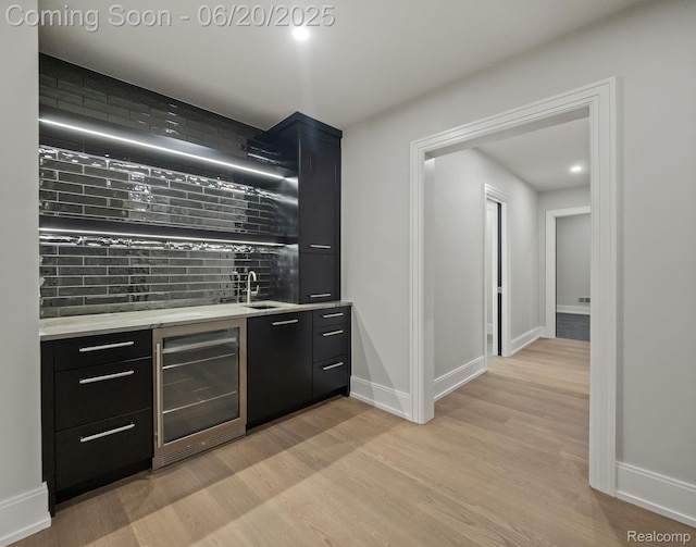 1120 Lyonhurst St, Birmingham, MI 48009 - indoor wet bar with wine cooler, light wood finished floors, and backsplash