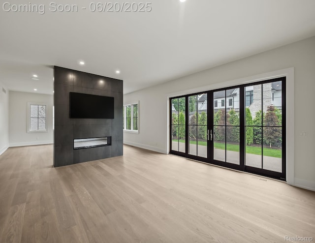 1120 Lyonhurst St, Birmingham, MI 48009 - unfurnished living room featuring light wood-type flooring, plenty of natural light, a large fireplace, and recessed lighting
