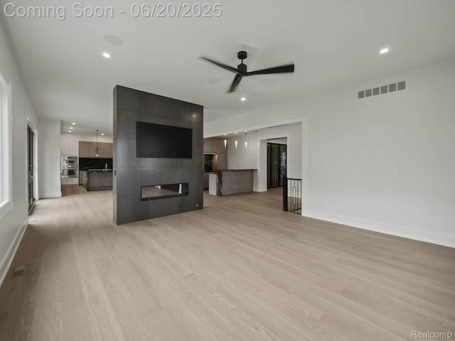 1120 Lyonhurst St, Birmingham, MI 48009 - unfurnished living room featuring light wood finished floors, ceiling fan, recessed lighting, and a fireplace