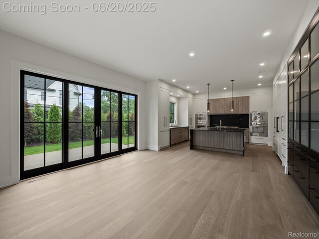 1120 Lyonhurst St, Birmingham, MI 48009 - unfurnished living room featuring light wood finished floors and recessed lighting