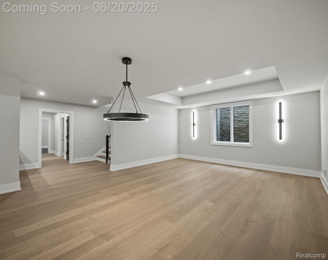 1120 Lyonhurst St, Birmingham, MI 48009 - unfurnished living room featuring stairway, light wood-style floors, recessed lighting, and a raised ceiling
