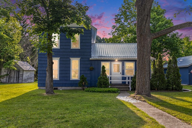 922 Marion Ave, Big Rapids, MI 49307 - view of front facade with a front lawn and a metal roof