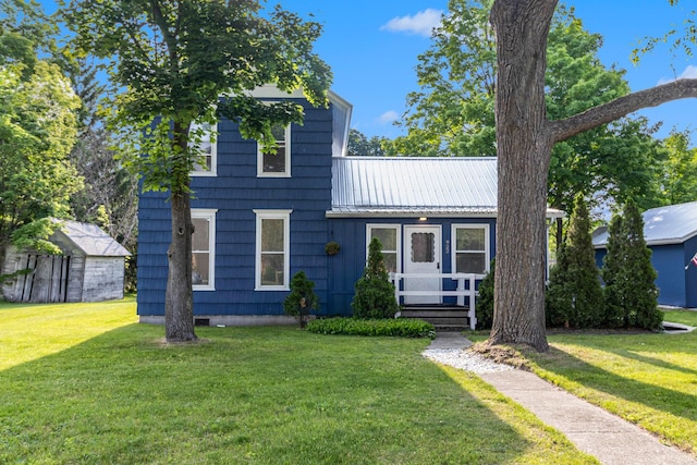 922 Marion Ave, Big Rapids, MI 49307 - view of front of property with a front yard and a metal roof
