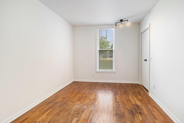 922 Marion Ave, Big Rapids, MI 49307 - unfurnished room with wood finished floors and baseboards