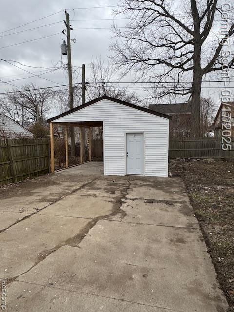 5215 Buckingham Ave, Detroit, MI 48224 - garage with concrete driveway and a carport