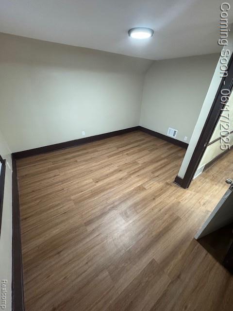 5215 Buckingham Ave, Detroit, MI 48224 - spare room with wood finished floors and lofted ceiling