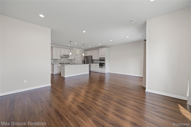 43629 Prospect Unit 102, Novi, MI 48375 - unfurnished living room featuring recessed lighting and dark wood-type flooring