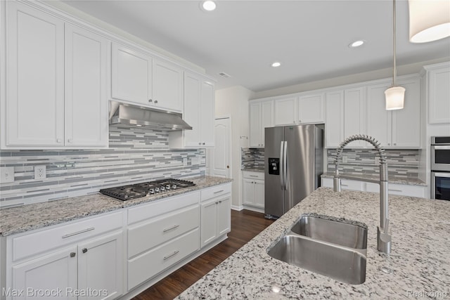 43629 Prospect Unit 102, Novi, MI 48375 - kitchen featuring appliances with stainless steel finishes, under cabinet range hood, decorative backsplash, white cabinetry, and recessed lighting