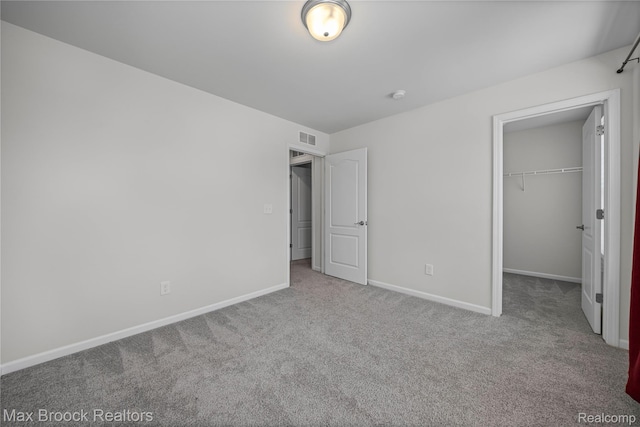 43629 Prospect Unit 102, Novi, MI 48375 - unfurnished bedroom featuring carpet flooring, a walk in closet, and a closet