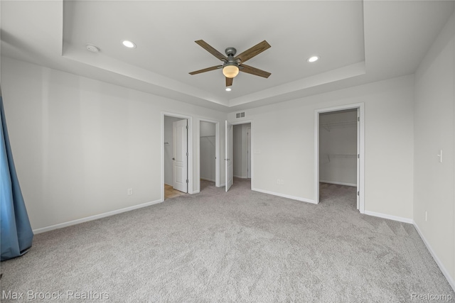 43629 Prospect Unit 102, Novi, MI 48375 - unfurnished bedroom with a raised ceiling, carpet floors, recessed lighting, a spacious closet, and a ceiling fan