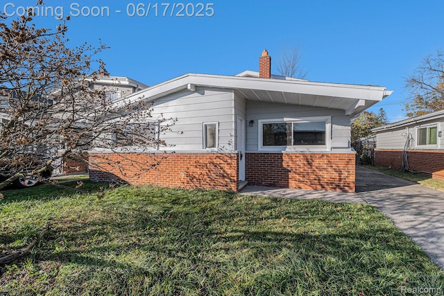 408 W Jarvis Ave, Hazel Park, MI 48030 - view of side of property featuring brick siding, a yard, and a chimney