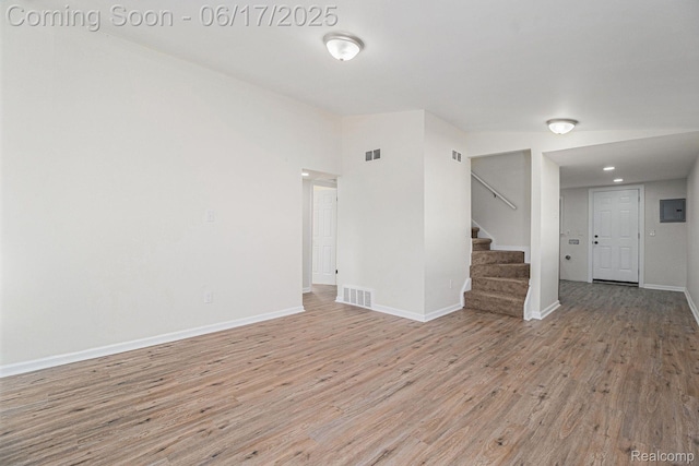 408 W Jarvis Ave, Hazel Park, MI 48030 - empty room with light wood-style floors, stairway, and electric panel