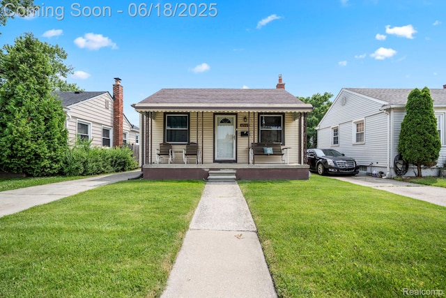 12925 Castle St, Southgate, MI 48195 - view of front of home featuring covered porch and a front lawn