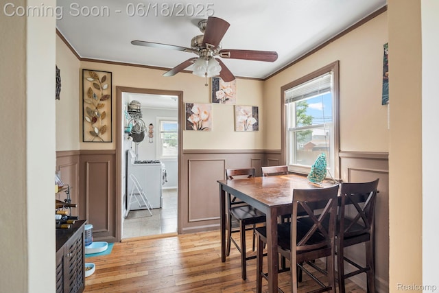 12925 Castle St, Southgate, MI 48195 - dining area featuring ornamental molding, plenty of natural light, wainscoting, light wood-style floors, and a decorative wall