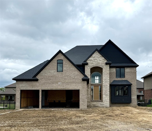 17102 Chianti Ct, Macomb, MI 48042 - french country home with brick siding, stone siding, and roof with shingles