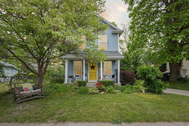857 Kalamazoo St, South Haven, MI 49090 - view of front of house featuring a front yard and a porch