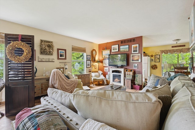 857 Kalamazoo St, South Haven, MI 49090 - living area featuring wood finished floors and a warm lit fireplace