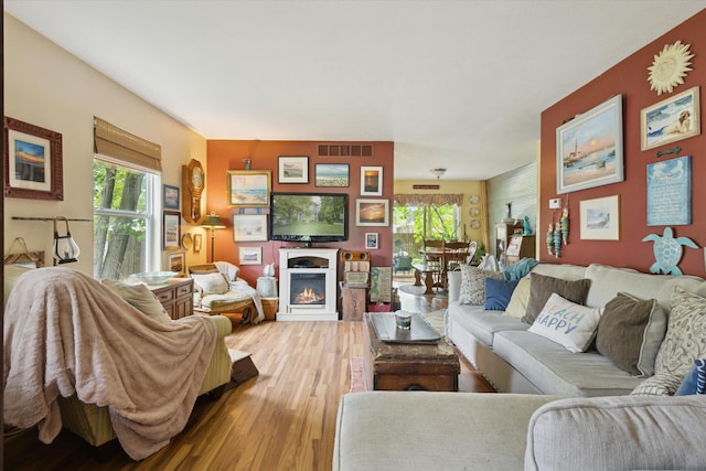 857 Kalamazoo St, South Haven, MI 49090 - living area with light wood-style floors and a lit fireplace