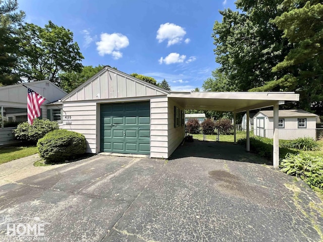 435 Brandon St, Owosso, MI 48867 - garage with driveway and an attached carport