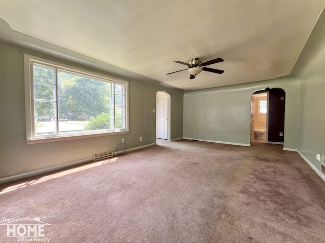 435 Brandon St, Owosso, MI 48867 - spare room with arched walkways, a ceiling fan, and carpet floors