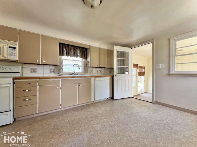 435 Brandon St, Owosso, MI 48867 - kitchen with white appliances, tasteful backsplash, and light countertops