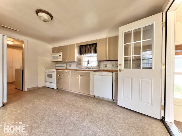 435 Brandon St, Owosso, MI 48867 - kitchen featuring white appliances and baseboards