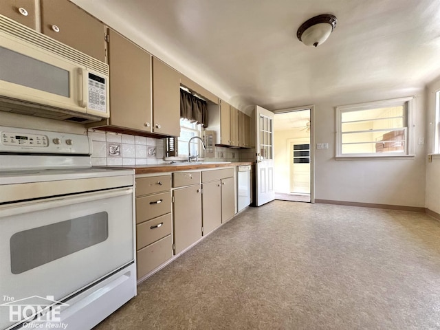 435 Brandon St, Owosso, MI 48867 - kitchen with white appliances, light countertops, and decorative backsplash