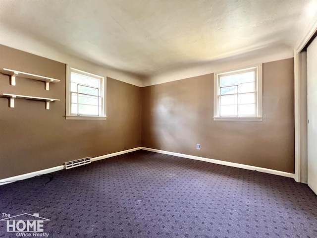 435 Brandon St, Owosso, MI 48867 - empty room featuring dark carpet