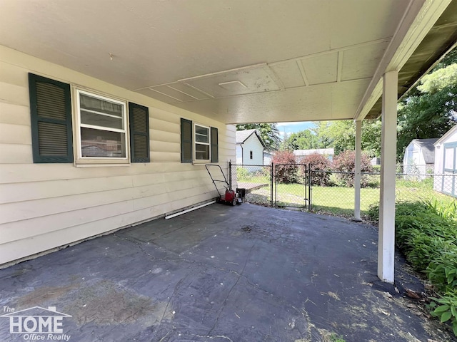 435 Brandon St, Owosso, MI 48867 - view of patio / terrace with a gate and a carport
